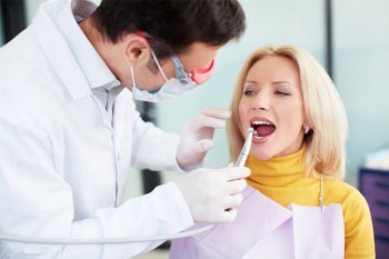 Dentist performing a dental procedure on a patient in Millersville, MD