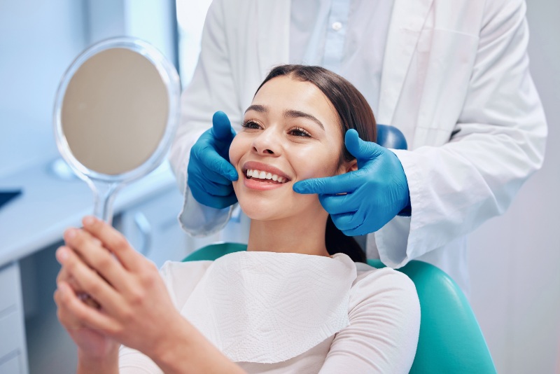 Young Woman Checking Her Results in the Dentist's Office in Millersville, MD